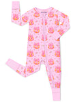 Pumpkin Bows zip-up romper with pink trim and a visible sole-grip cuff, laid flat on white.