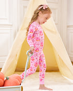 Side view of a child standing beside a cart in Pumpkin Bows pajamas.