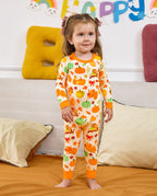 Child standing on a sofa in Pumpkin Patch long-sleeve pajamas.