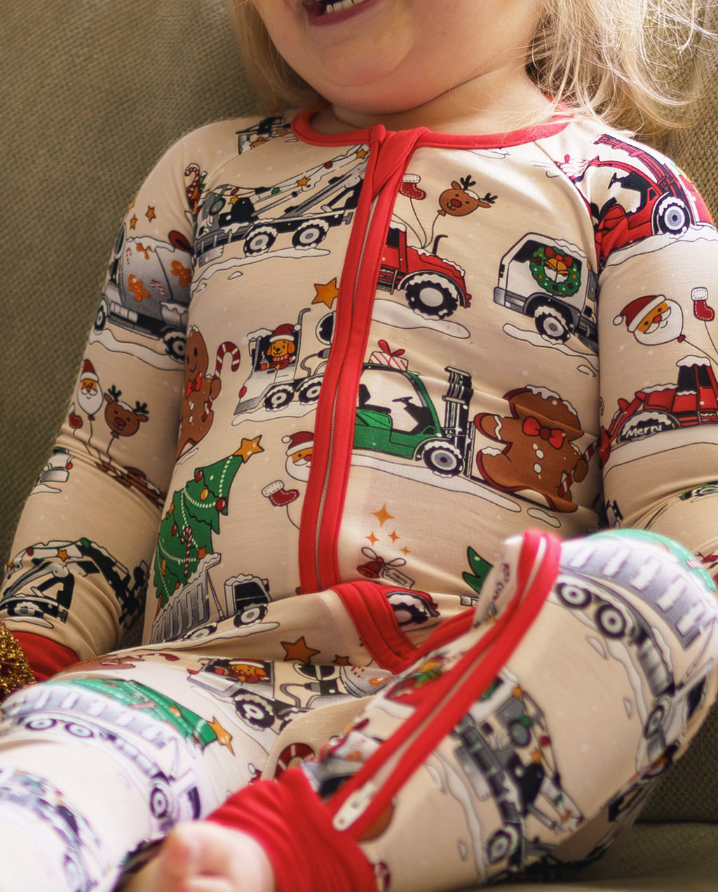 Close-up of Santa Express zippy showing red zipper, holiday trucks, gifts, and gingerbread characters