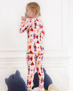 Rear view of a child standing with a lollipop in the Sugarplum Wishes pajama set.