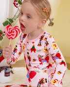 Close-up of a child with a swirl lollipop in the Sugarplum Wishes pajama top.
