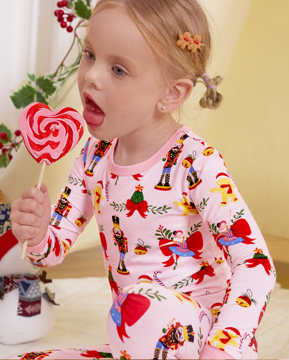 Close-up of a child with a swirl lollipop in the Sugarplum Wishes pajama top.