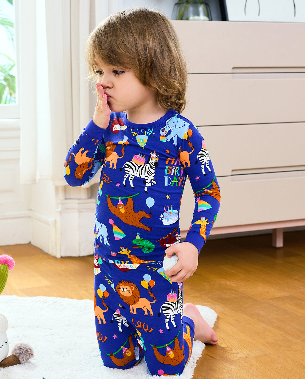 Child standing in Birthday Safari animal-print pajamas