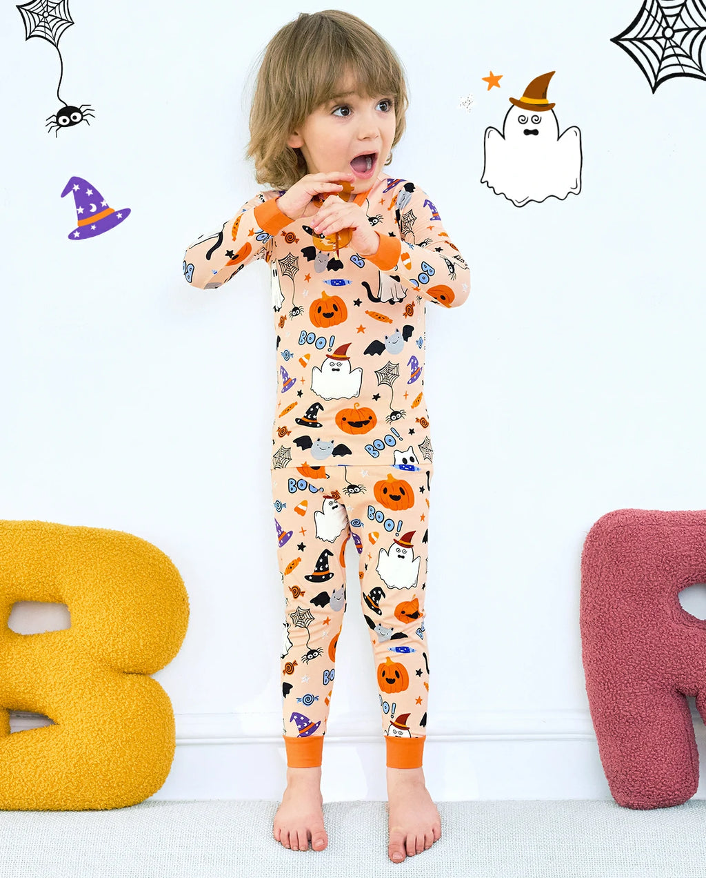 Boo Treats Long Two-Piece Pajama Set - child wearing the pajamas with Halloween wall decorations