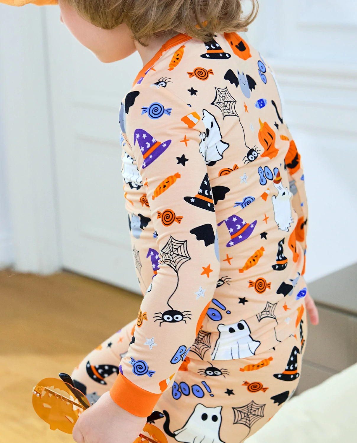 Boo Treats Long Two-Piece Pajama Set - child wearing the pajamas while walking, side view