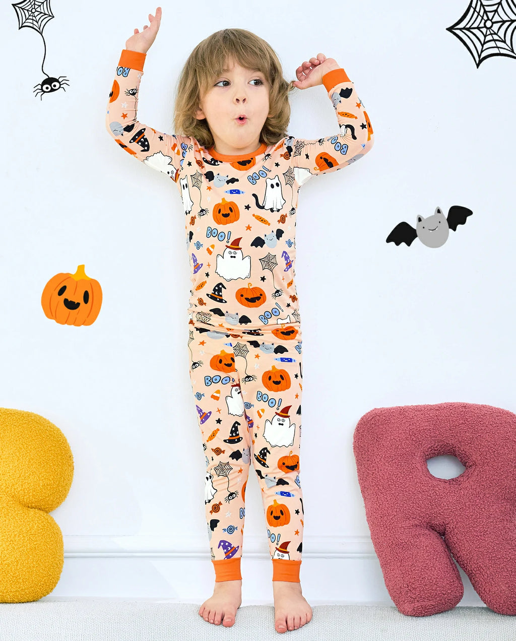 Boo Treats Long Two-Piece Pajama Set - child wearing the pajamas with both arms raised, front view