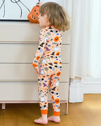 Boo Treats Long Two-Piece Pajama Set - child wearing the pajamas while standing, side view