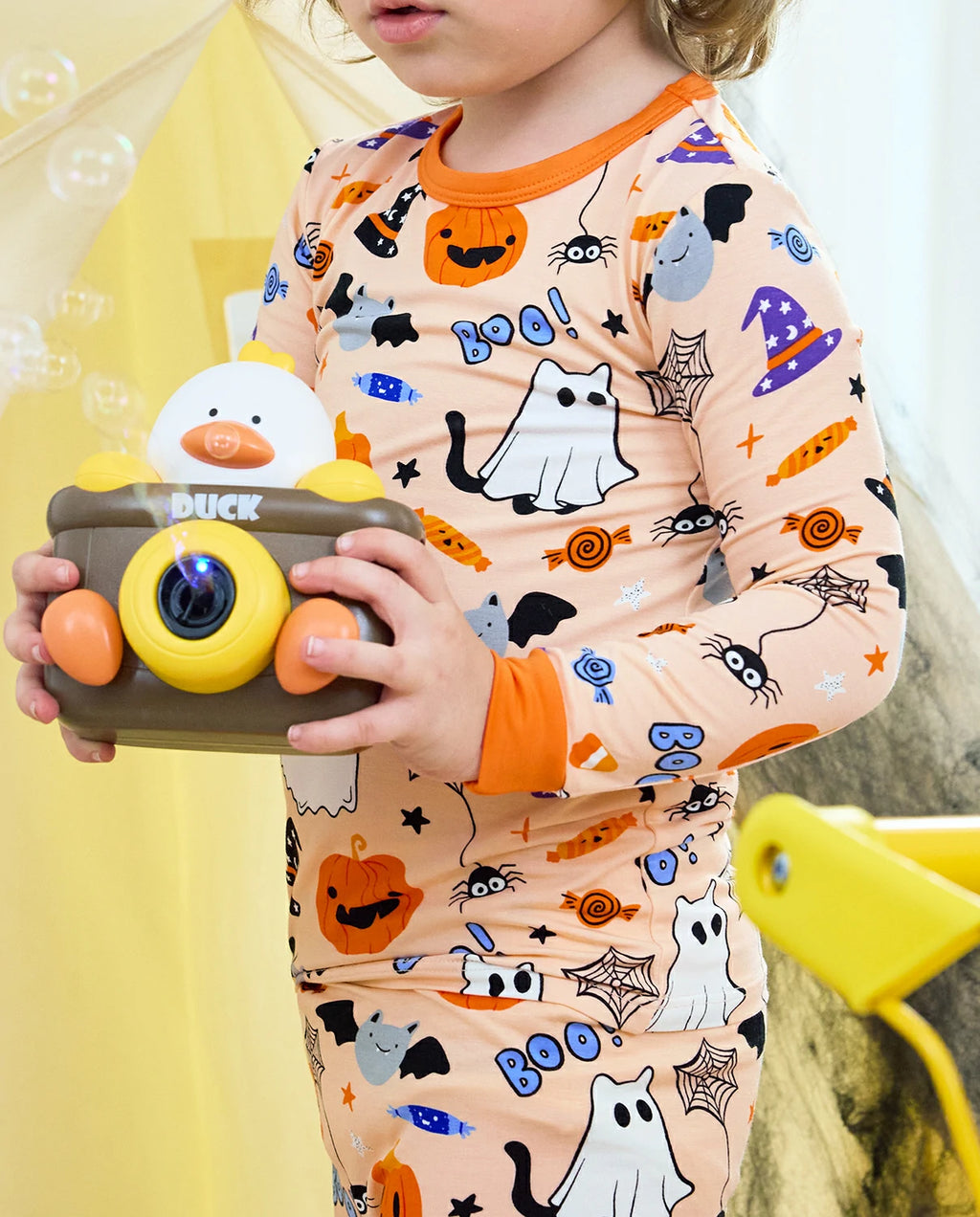 Boo Treats Long Two-Piece Pajama Set - close-up of the pajama print while holding a toy camera