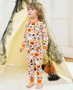 Boo Treats Long Two-Piece Pajama Set - child wearing the pajamas in a Halloween tent scene