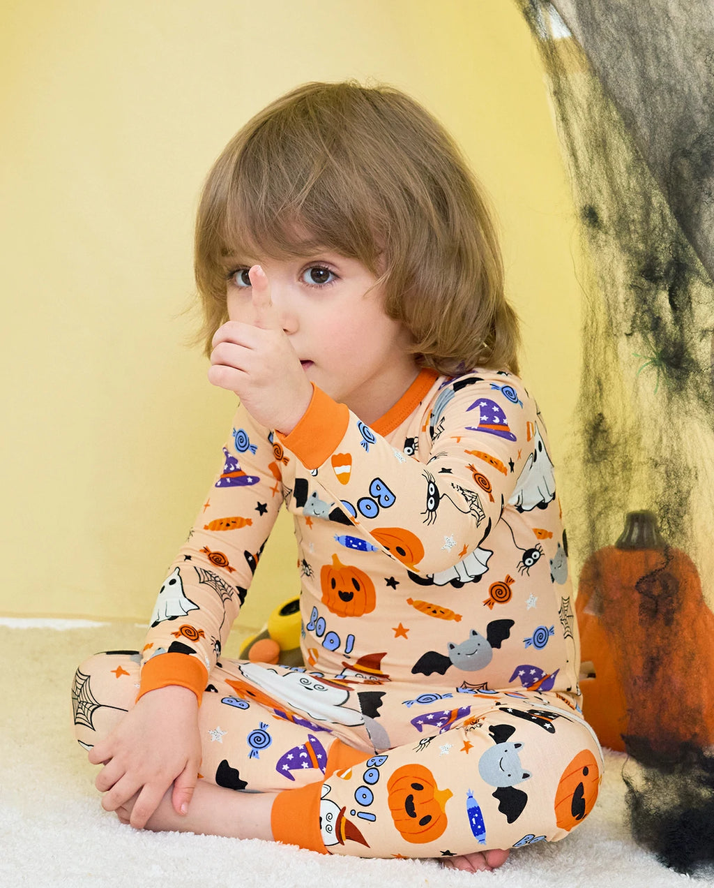 Boo Treats Long Two-Piece Pajama Set - child wearing the pajamas while seated in a Halloween tent