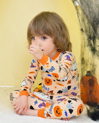 Boo Treats Long Two-Piece Pajama Set - child wearing the pajamas while seated in a Halloween tent