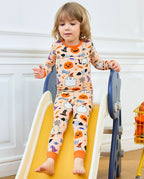 Boo Treats Long Two-Piece Pajama Set - child wearing the pajamas while seated on a play slide