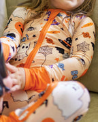 Boo Treats Bamboo Zippy close-up showing orange zipper and Halloween print details