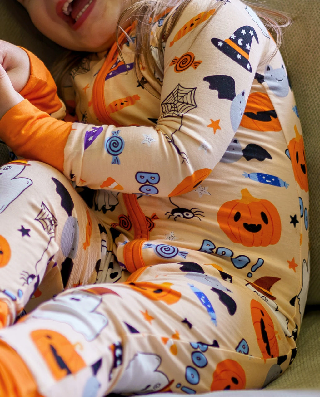 Close-up of Boo Treats Bamboo Zippy sleeve with pumpkin candy bat and BOO print
