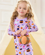 Candy Boo Long Two-Piece Pajama Set - child wearing the pajamas while standing with a plush pumpkin