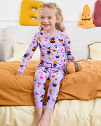 Candy Boo Long Two-Piece Pajama Set - child wearing the pajamas while seated on a bed