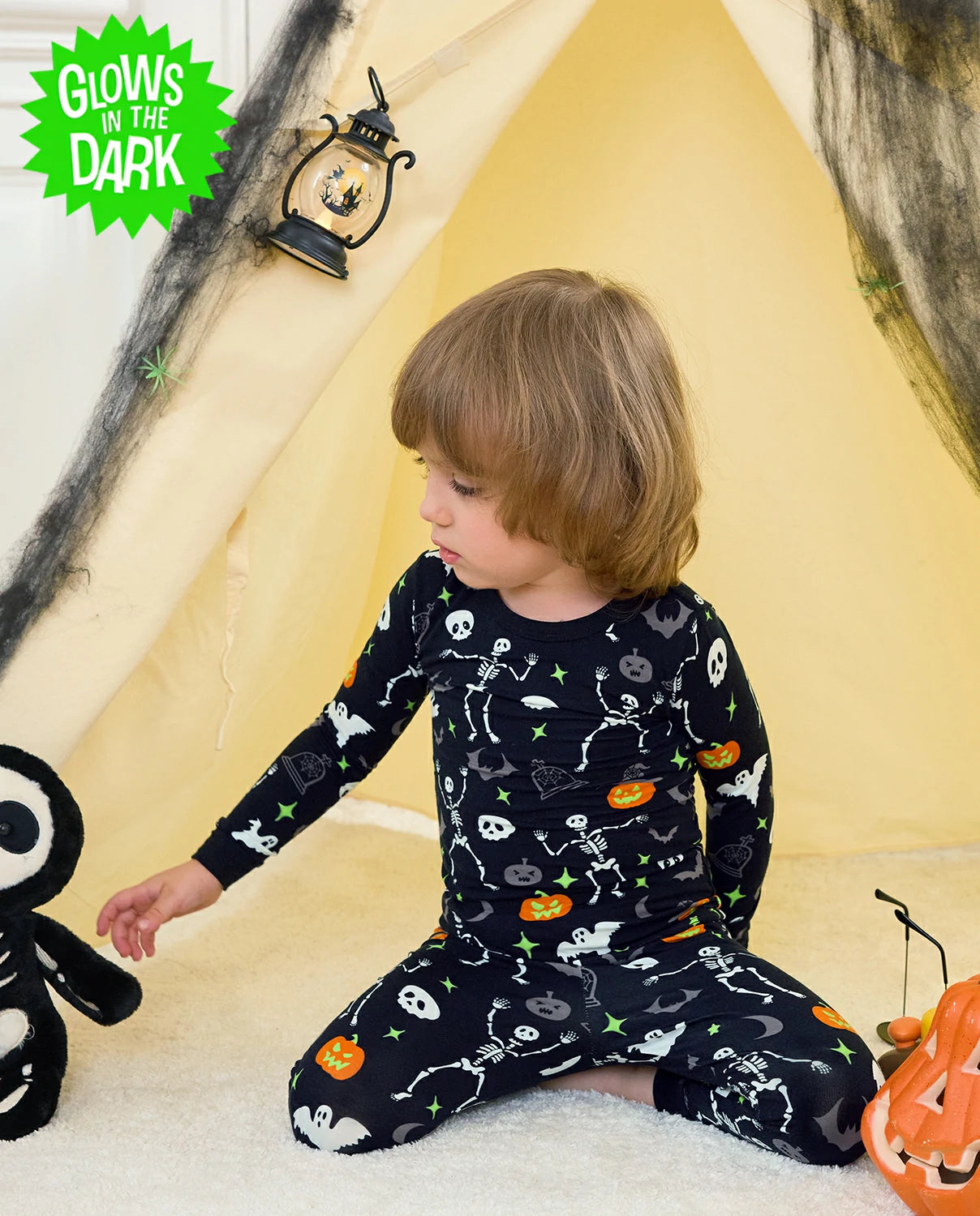 Dark Disco Long Two-Piece Pajama Set - child wearing the glow-print pajamas while seated