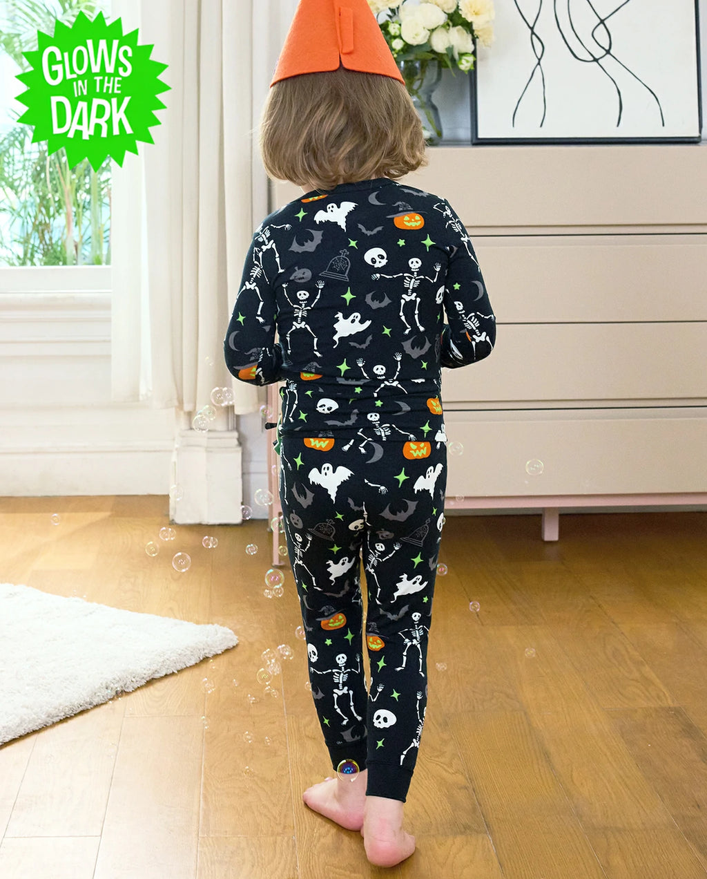 Dark Disco Long Two-Piece Pajama Set - child wearing the glow-print pajamas, back view