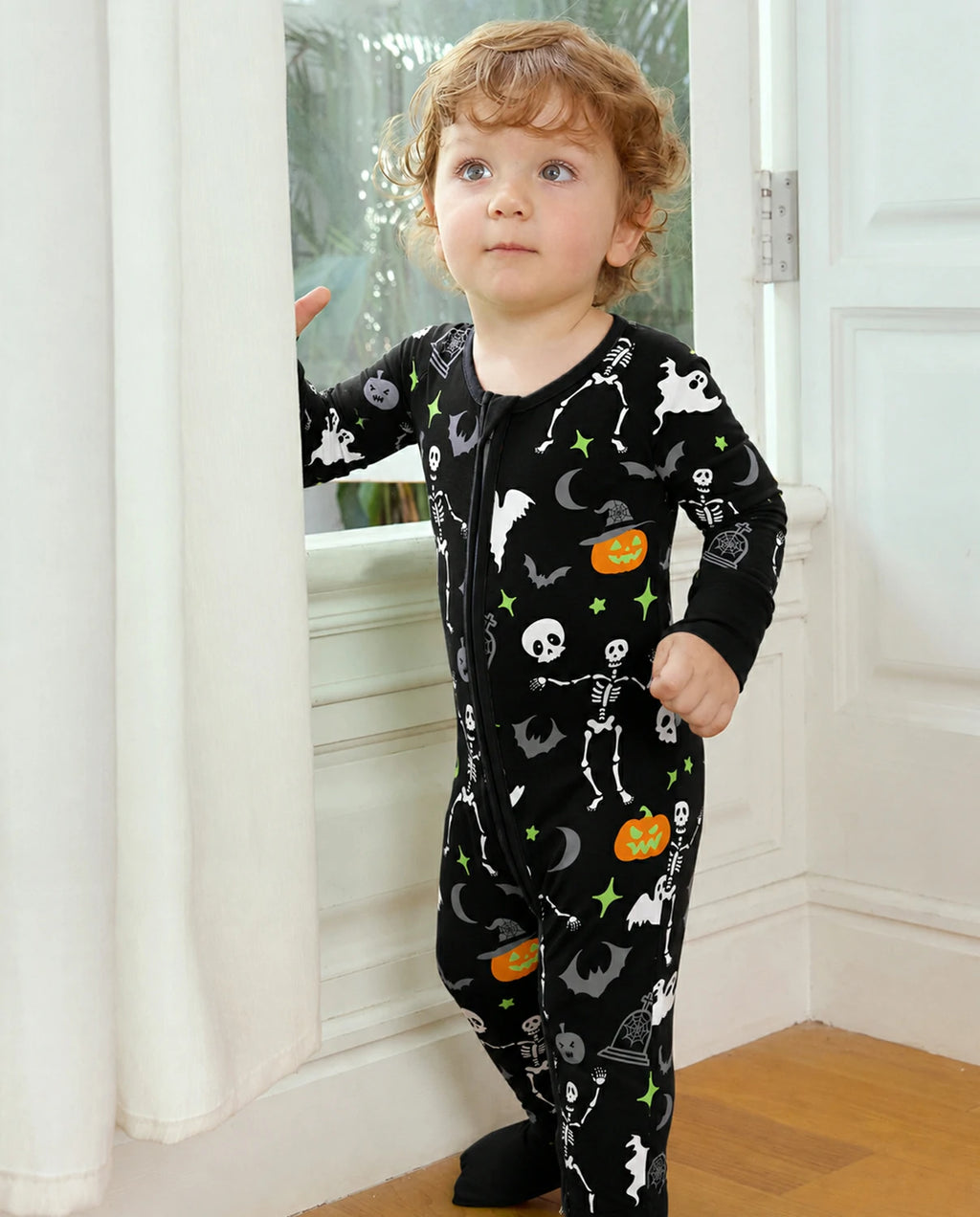 Child standing by a window in Dark Disco Bamboo Zippy with spooky Halloween print
