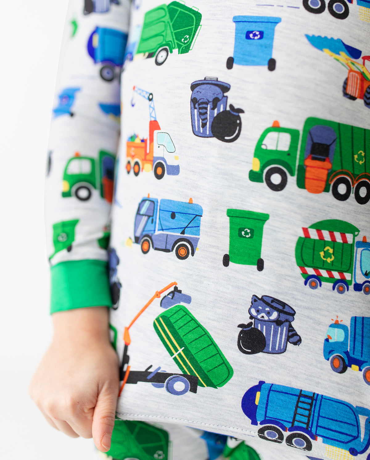 Close view of garbage-truck print and green cuffs on light grey pajamas