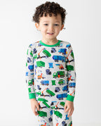 Child standing in grey Garbage Squad pajamas with green trim