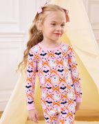Ghost Bows Long Two-Piece Pajama Set - child wearing the ghost-and-bow pajamas while standing, three-quarter view