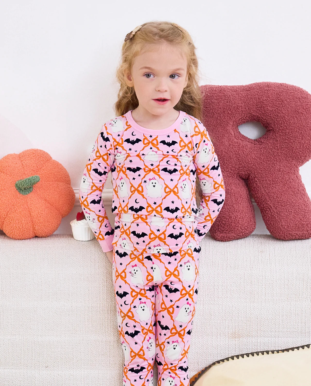 Ghost Bows Long Two-Piece Pajama Set - child wearing the ghost-and-bow pajamas, full-length front view