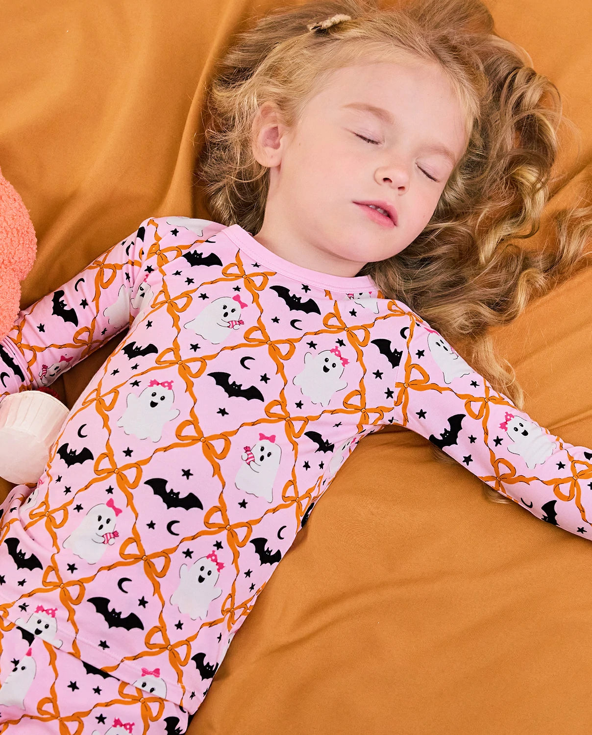 Ghost Bows Long Two-Piece Pajama Set - child sleeping in the ghost-and-bow pajamas