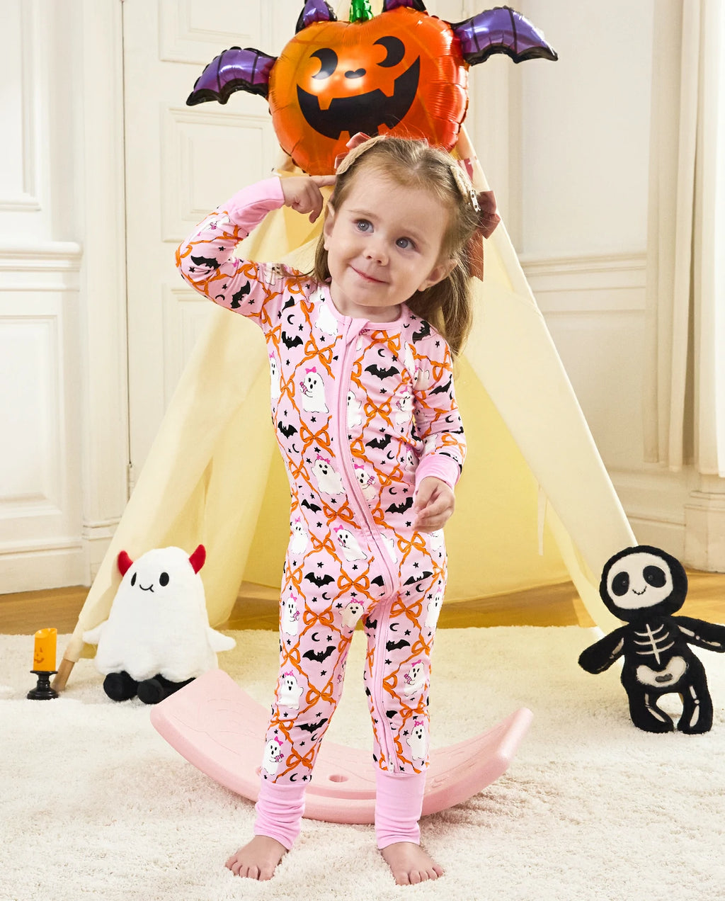 Baby wearing Ghost Bows Bamboo Zippy with pink Halloween ghost and bat print