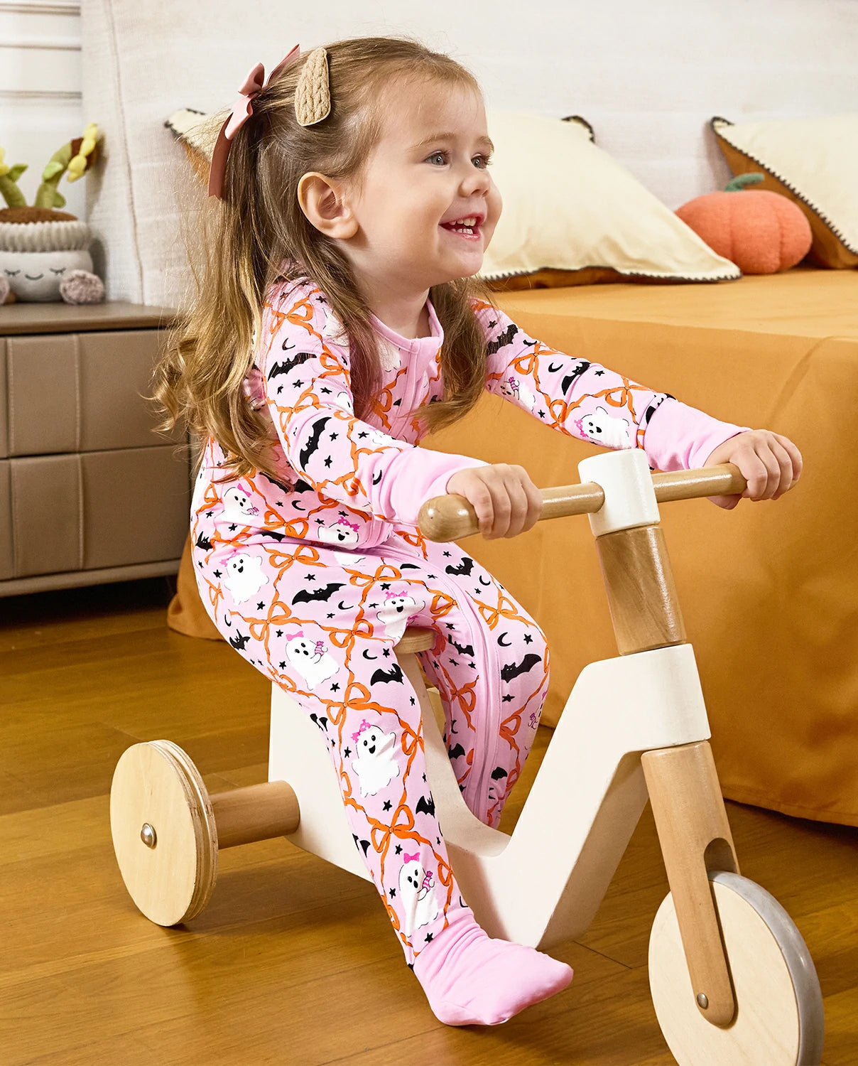Baby wearing Ghost Bows Bamboo Zippy during indoor playtime