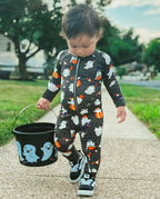 Toddler walking outdoors in Ghostie Sports Club Bamboo Zippy carrying a Halloween ghost bucket
