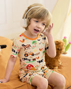 Happy Farmyard Short Two-Piece Pajama Set - child wearing the short pajamas while seated with headphones