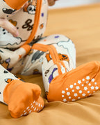 Close-up of orange grippy footies on Happy Hallowboo Bamboo Zippy