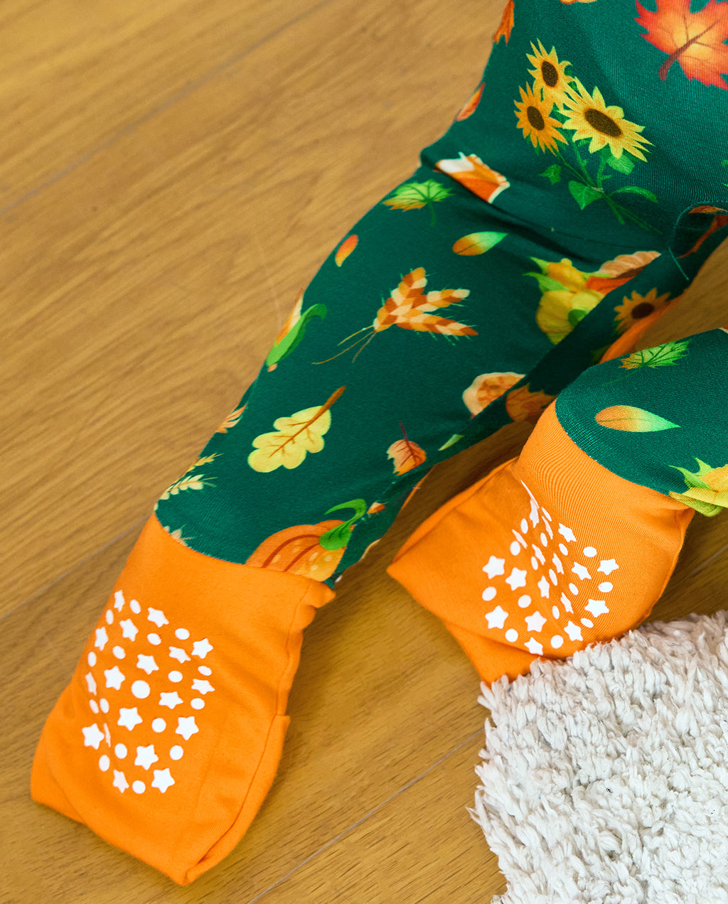 Close-up of Harvest Feast Bamboo Zippy orange foot cuffs with white grip dots.
