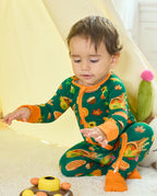 Baby seated in Harvest Feast Bamboo Zippy with orange two-way zipper and harvest print.