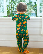 Full back view of a baby in Harvest Feast Bamboo Zippy by a window.
