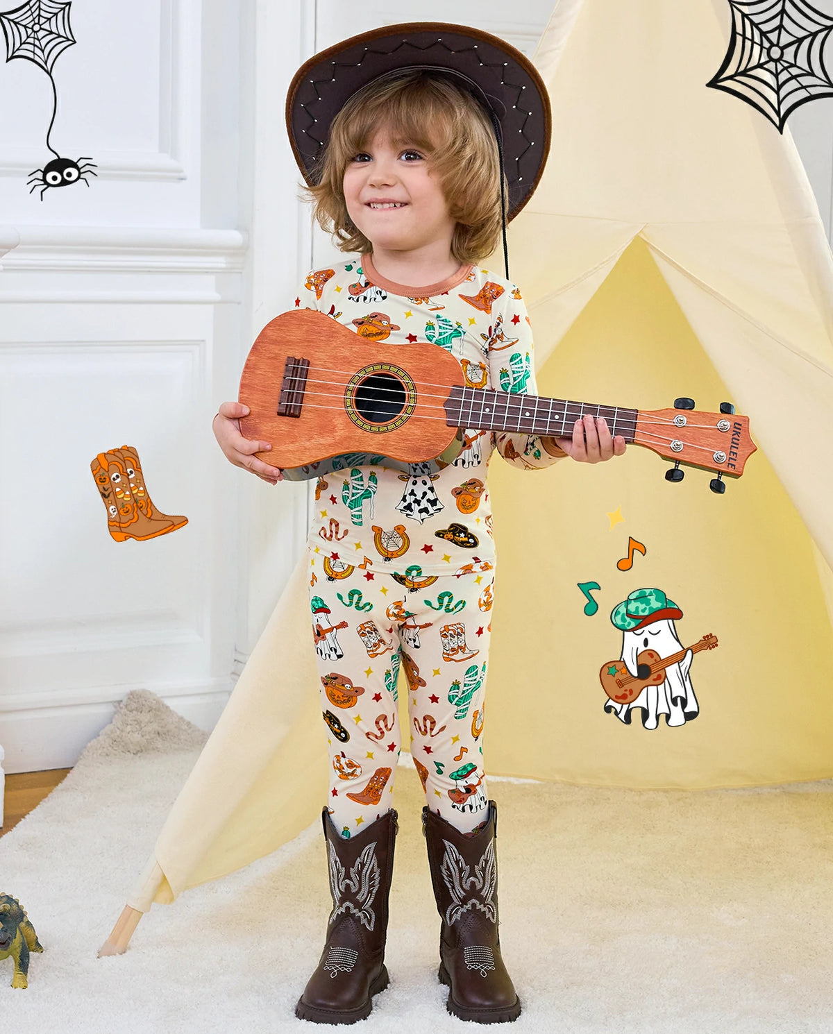 Howdy Halloween Long Two-Piece Pajama Set - child wearing the pajamas with a cowboy hat and ukulele