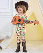 Howdy Halloween Long Two-Piece Pajama Set - child wearing the pajamas with cowboy boots and a ukulele