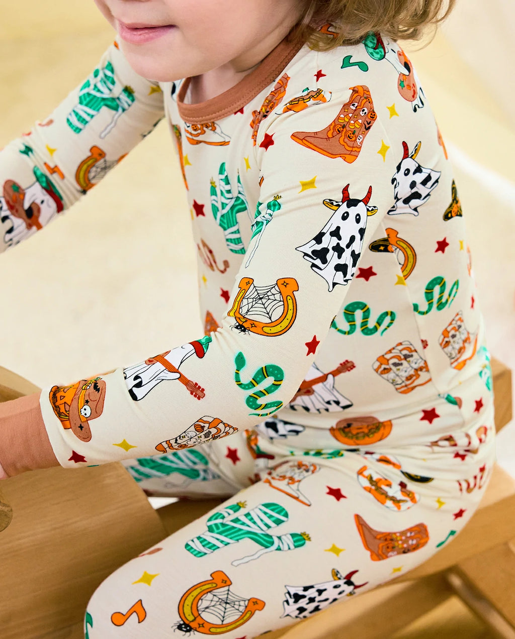 Howdy Halloween Long Two-Piece Pajama Set - close-up of the western print and brown cuffs