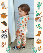 Child in Howdy Halloween Bamboo Zippy standing by a door with western Halloween print graphics