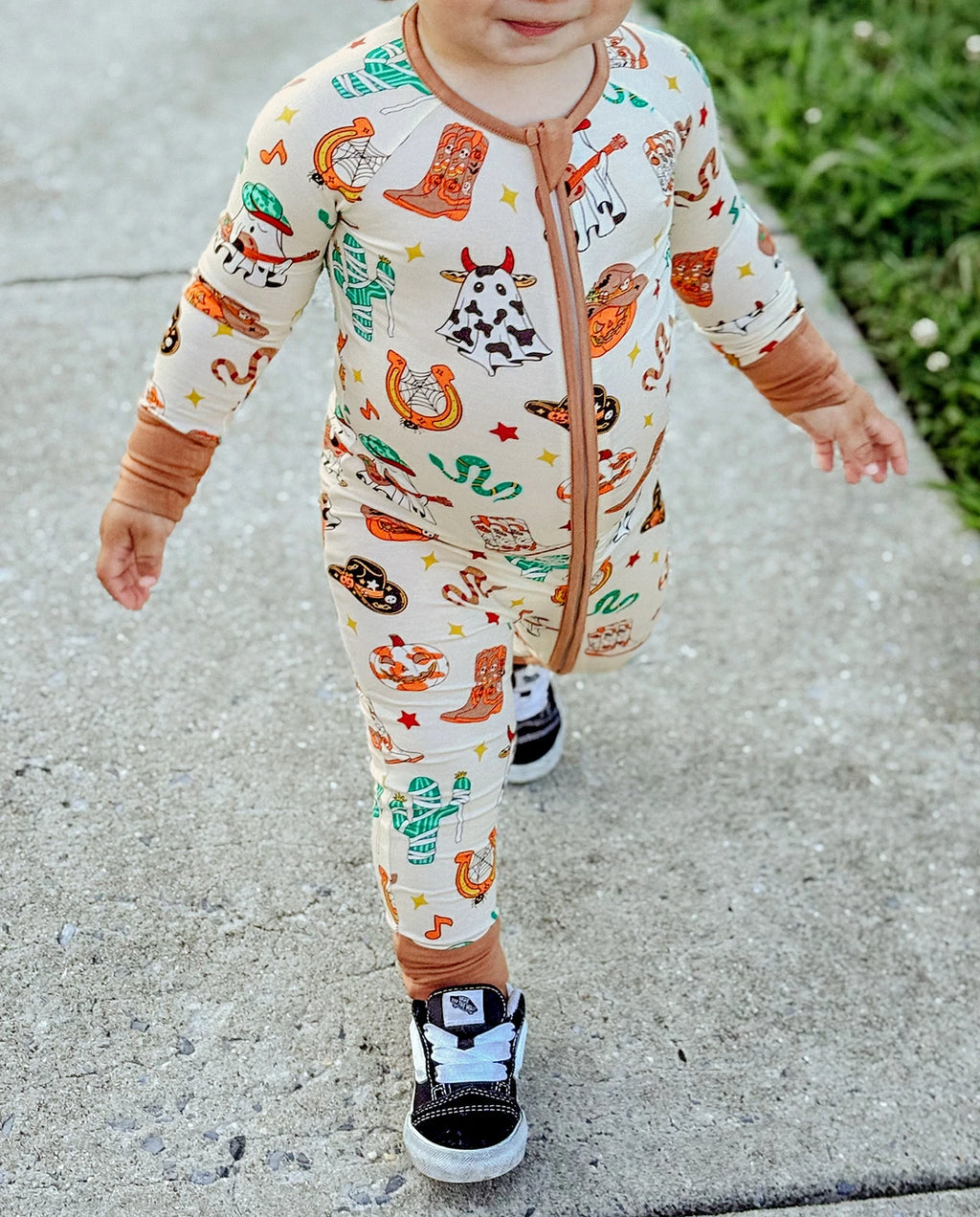 Close-up of Howdy Halloween Bamboo Zippy showing western Halloween print and two-way zipper