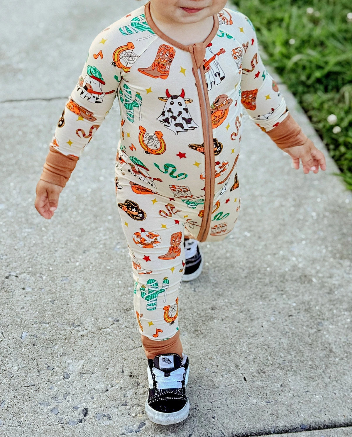 Close-up of Howdy Halloween Bamboo Zippy showing western Halloween print and two-way zipper