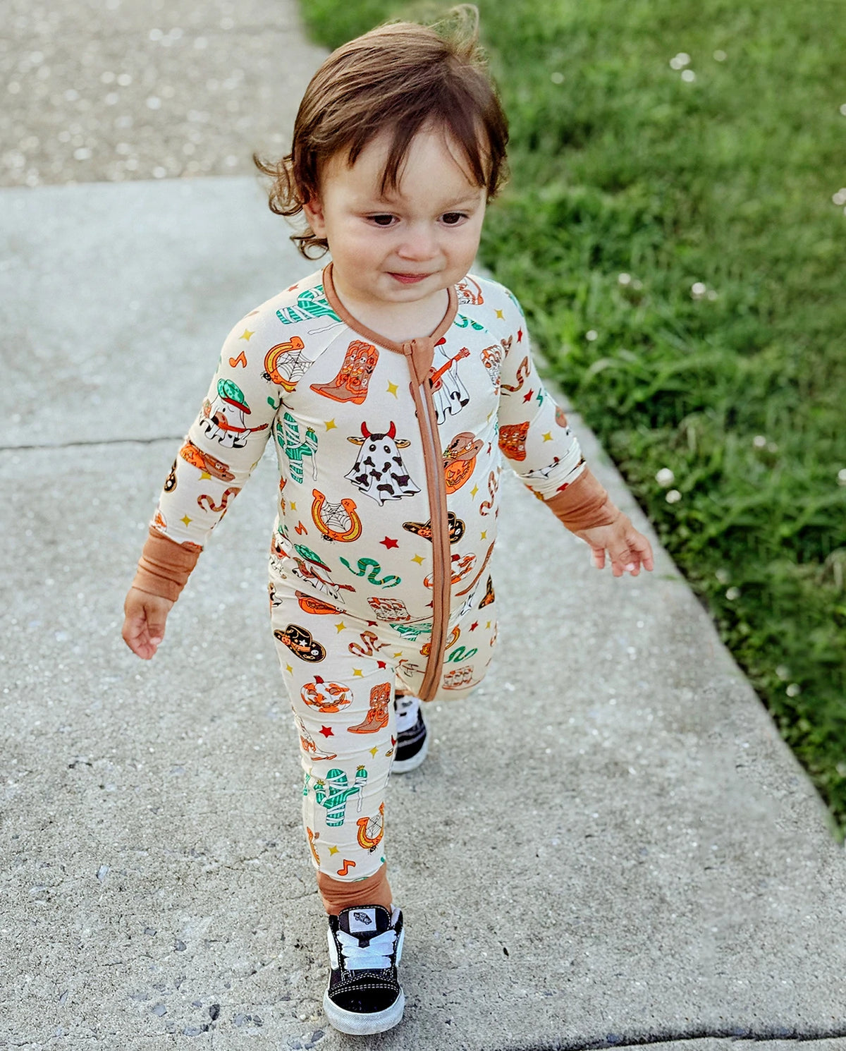 Child walking outdoors in Howdy Halloween Bamboo Zippy with soft stretch fabric and Halloween western print
