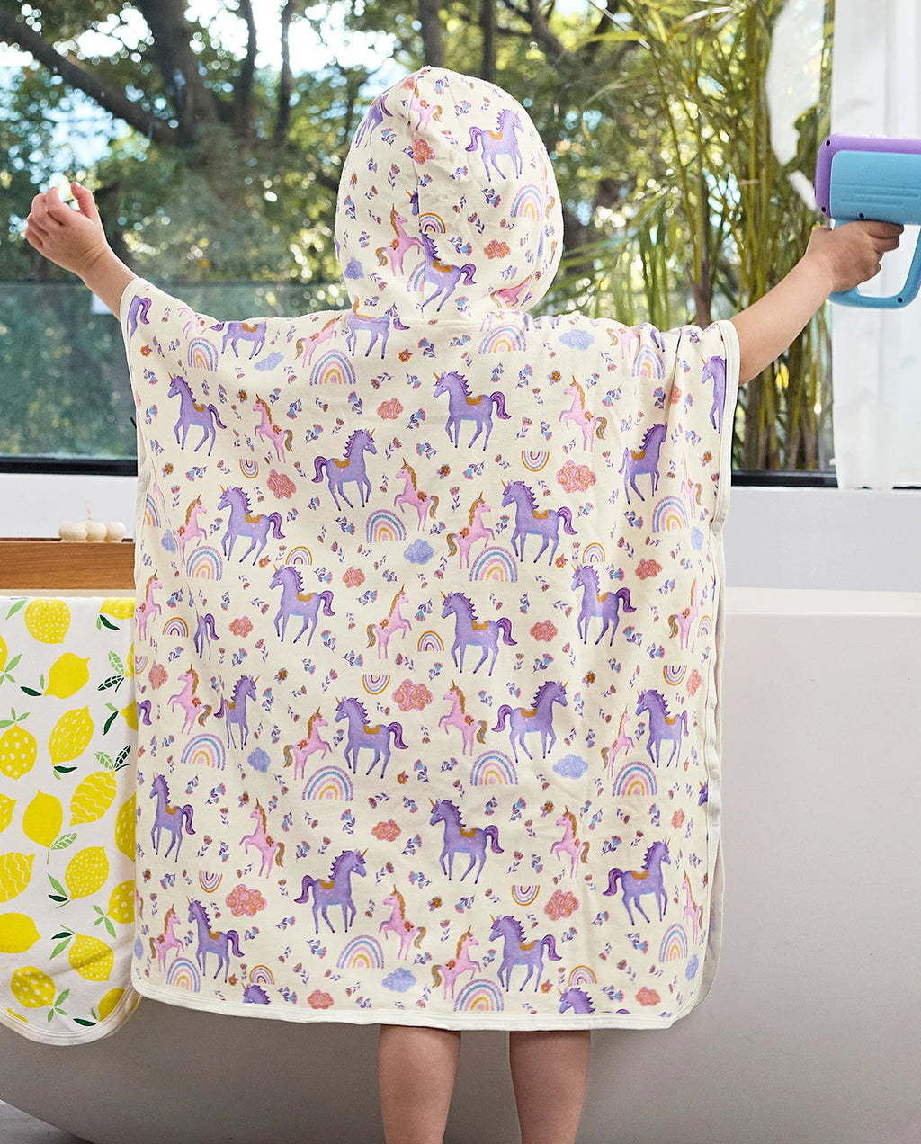 Lavender Unicorn Hooded Toddler Bath Towel - child wearing the unicorn-print hooded towel, back view