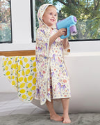 Lavender Unicorn Hooded Toddler Bath Towel - child wearing the hooded towel while holding a water toy