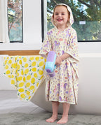 Lavender Unicorn Hooded Toddler Bath Towel - child wearing the hooded towel and holding a water toy, front view
