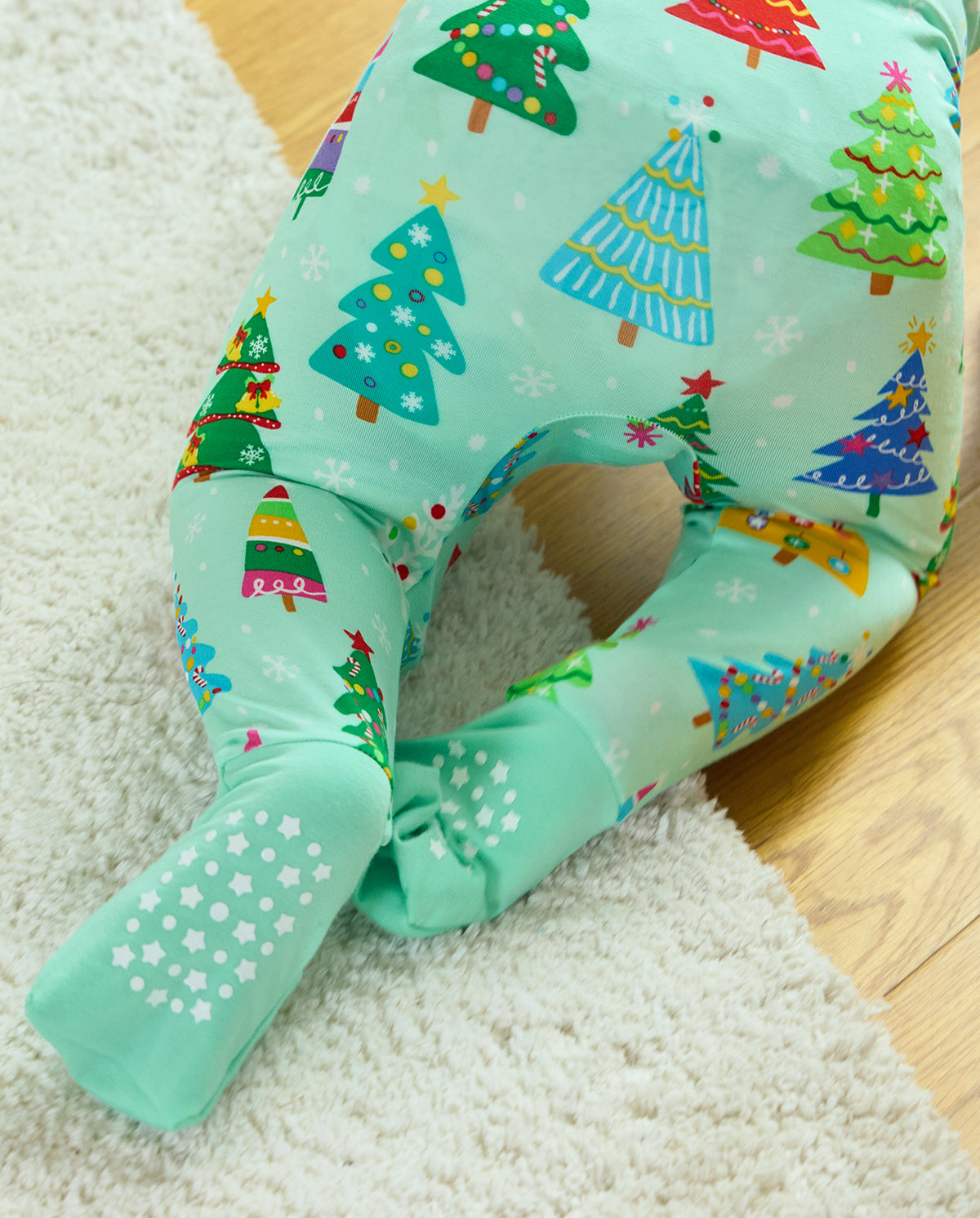 Close-up of Merry Trees Bamboo Zippy covered feet with white star-shaped grips