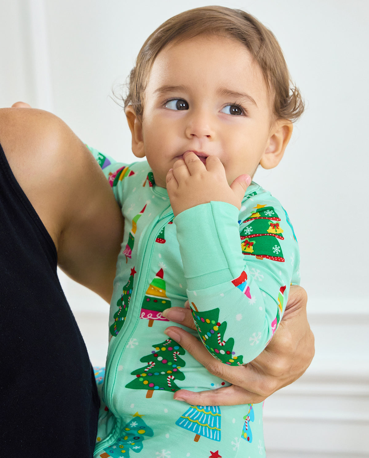 Close-up of a baby held in the Merry Trees Bamboo Zippy showing the front zipper and sleeve cuff