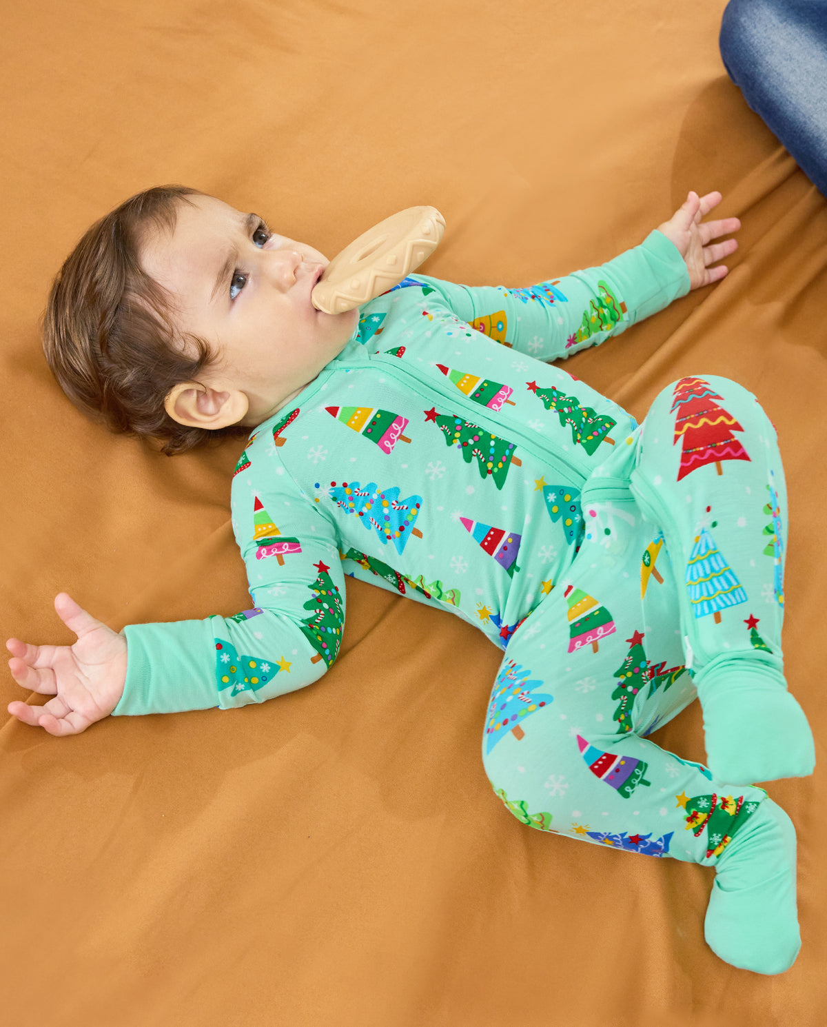 Baby reclining in the mint-green Merry Trees Bamboo Zippy with the front zipper visible